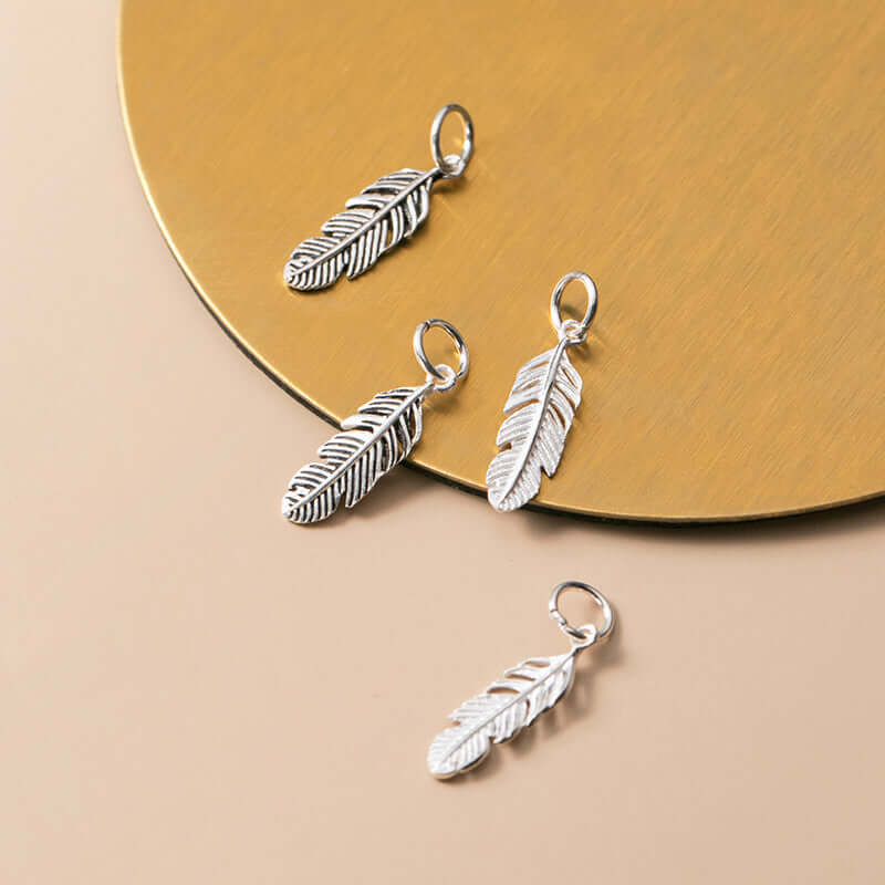"Artisan handmade feather pendant charm for crafting"