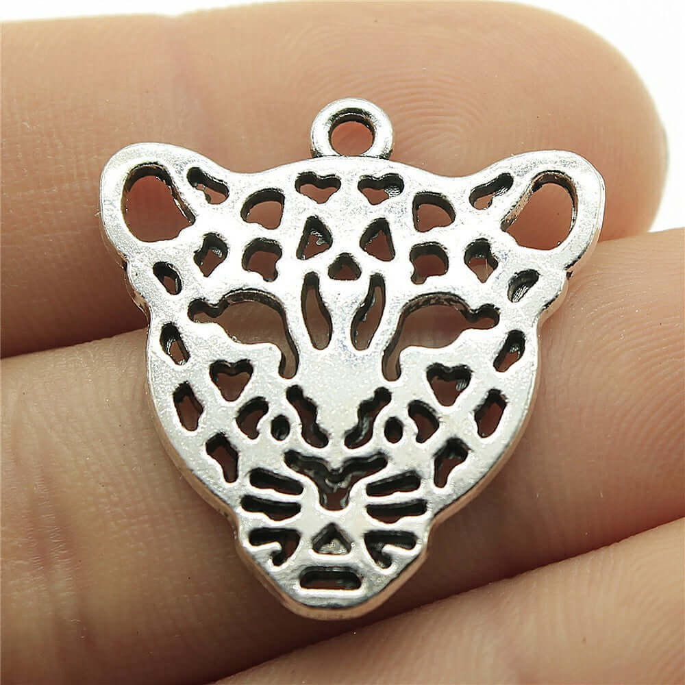 Handmade leopard head pendant in silver metal, perfect for DIY jewelry projects.