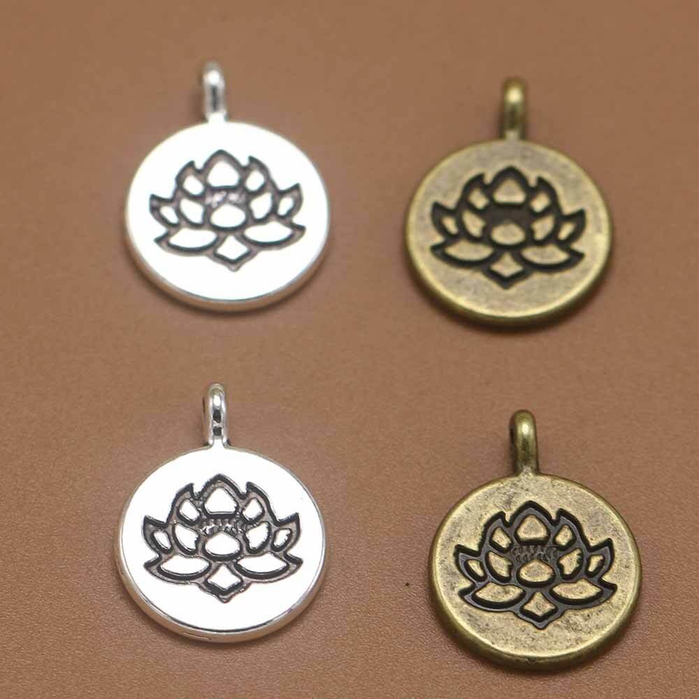 Vintage alloy round lotus pendants in silver and bronze colors, handmade jewelry displayed on a brown background.