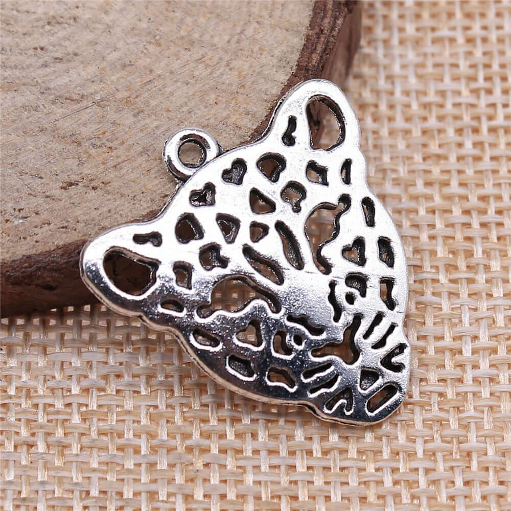 Handmade leopard head pendant in antique silver with intricate cut-out design, ideal for jewelry accessories.