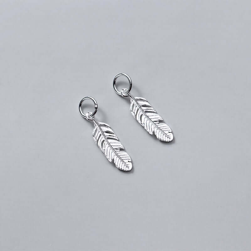 "Minimalist handmade feather pendant jewelry design"
