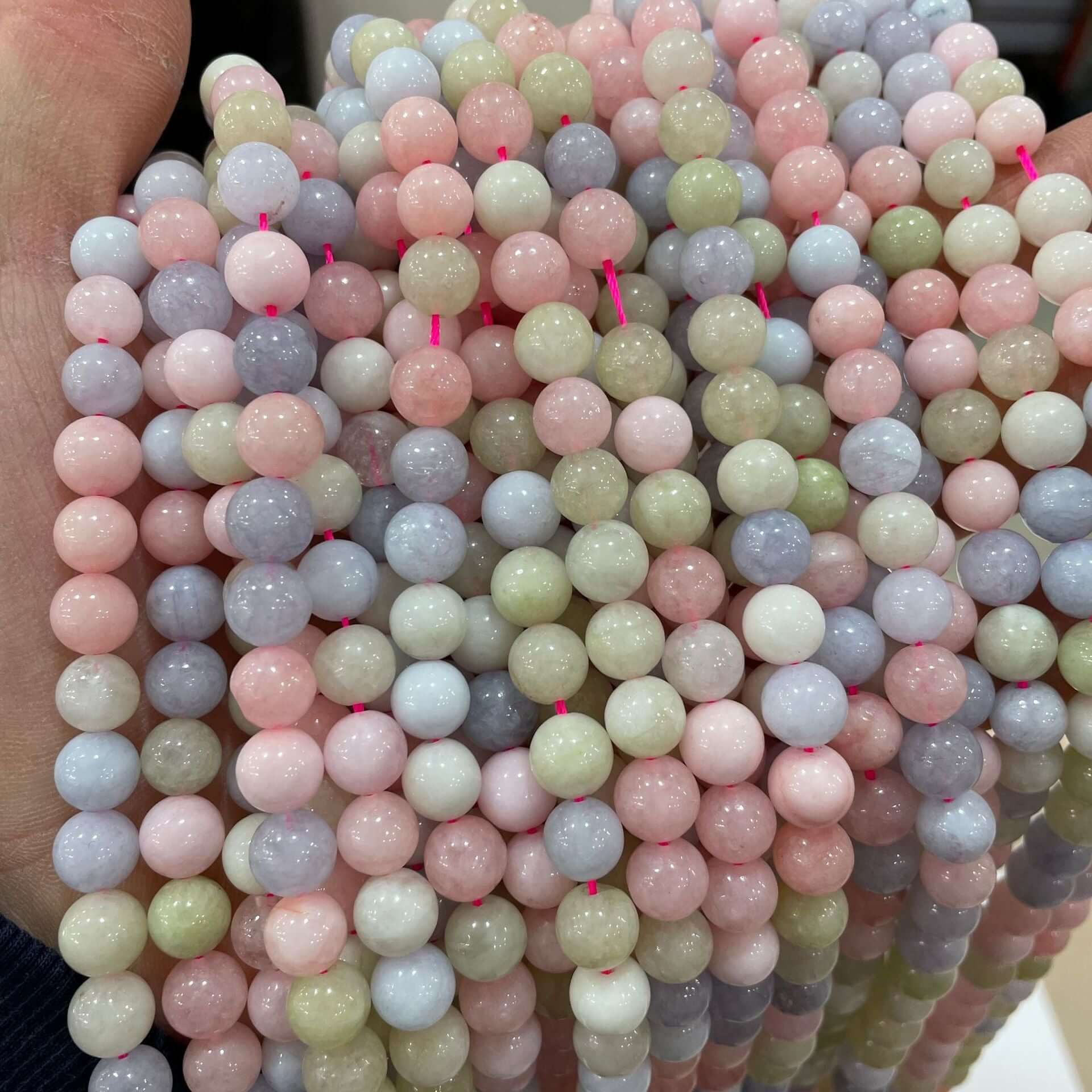 Colorful morganite loose beads in various sizes for DIY handmade jewelry, showcasing a range of pastel hues.
