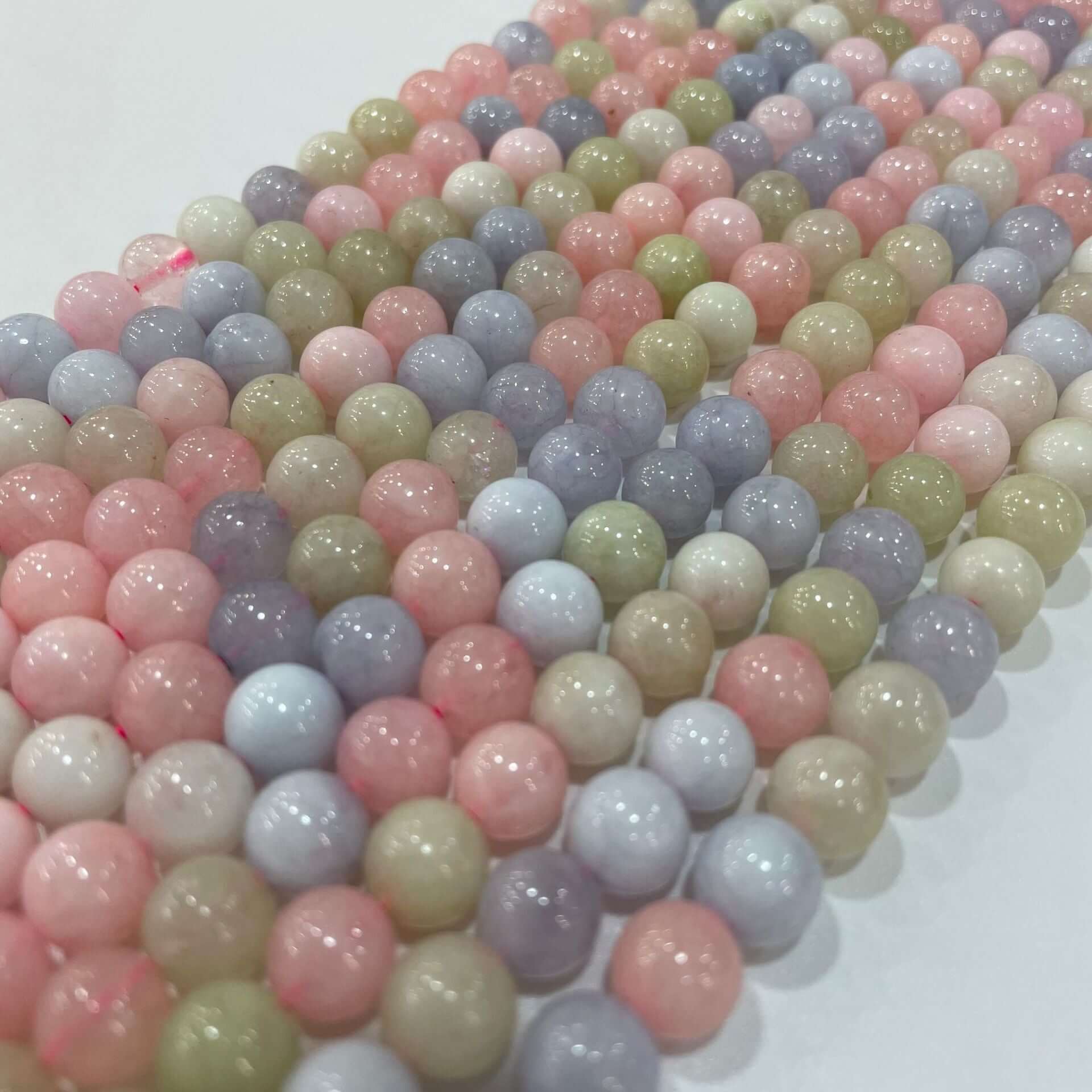 Colorful morganite loose beads in various sizes for DIY handmade jewelry, showcasing pastel hues and glossy finish.
